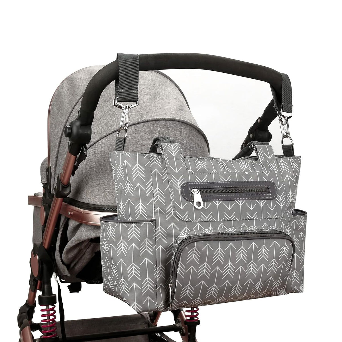 Gray diaper bag attached to a stroller with adjustable stroller straps and exterior storage pockets by Mama's Dream