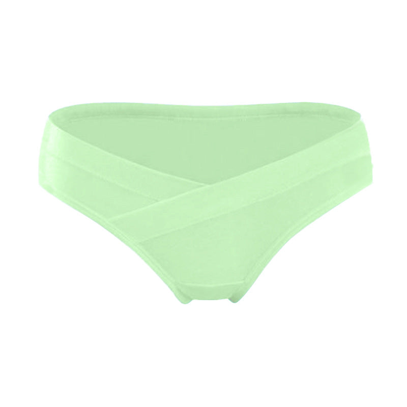 Light green maternity underwear with a crossover waistband that sits below the belly, shown on a white background by Mama's Dream