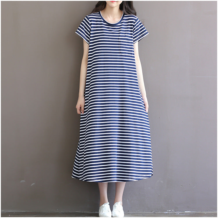 Front view of a woman wearing a loose navy and white striped maternity maxi dress by Mama's Dream
