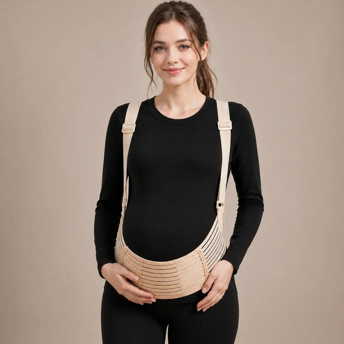 Pregnant woman wearing a beige pregnancy belly support belt with adjustable shoulder straps by Mama's Dream