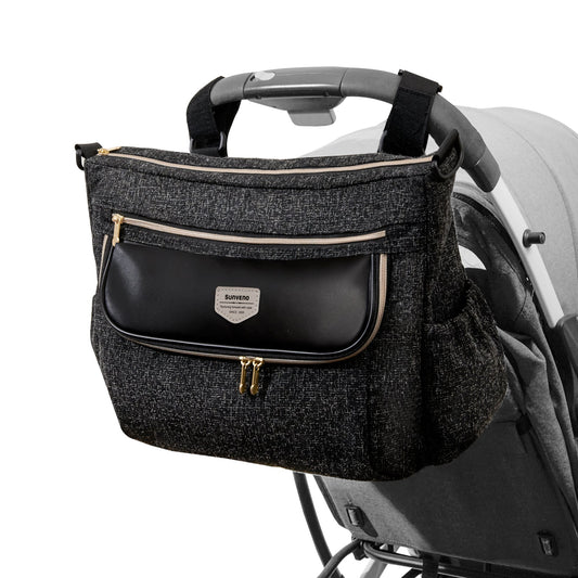 Black stroller diaper bag organizer with multiple zippered pockets attached to a baby stroller by Mama's Dream