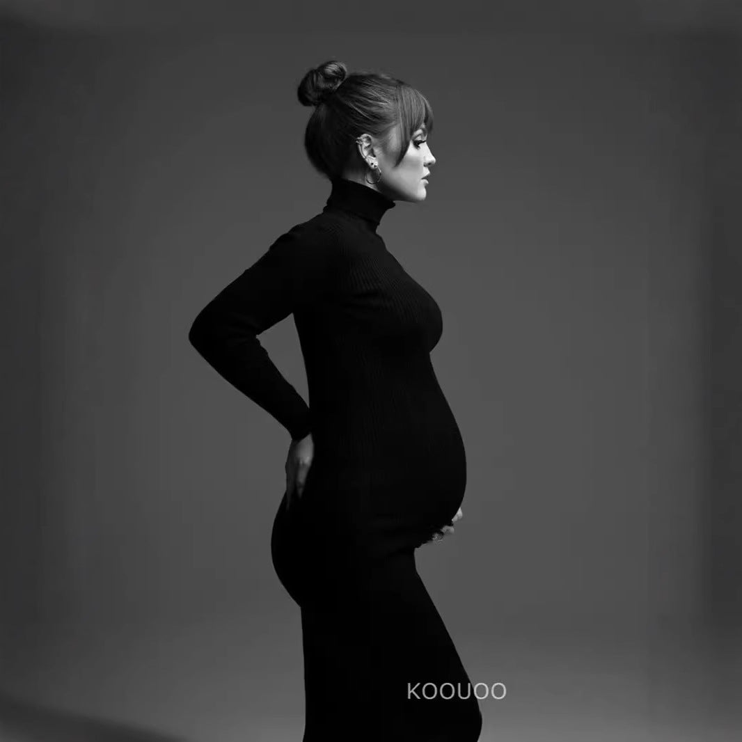 Black long sleeve maternity photoshoot dress with turtleneck and fitted floor length silhouette by Mama's Dream