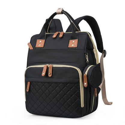 Black quilted diaper bag backpack with top handles, padded shoulder straps and side accessory pouch by Mama's Dream