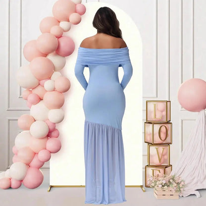 Light blue off shoulder maternity gown with long sleeves and flowing mermaid hem shown from the back by Mama's Dream