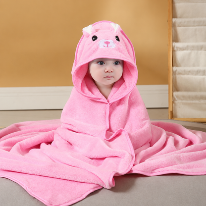 Baby wrapped in a soft bright pink hooded bath towel with an embroidered bear design by Mama's Dream