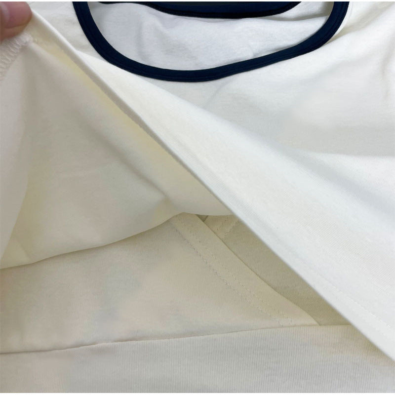 Close-up of the hidden breastfeeding access inside a cream maternity nursing T-shirt by Mama's Dream