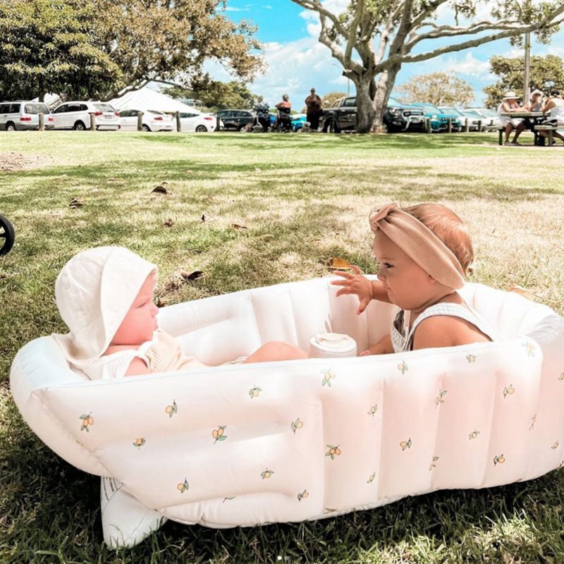 Inflatable baby bathtub being used outside
