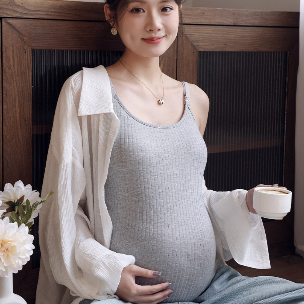 Pregnant woman wearing a gray ribbed maternity nursing tank top with adjustable drop-down straps by Mama's Dream