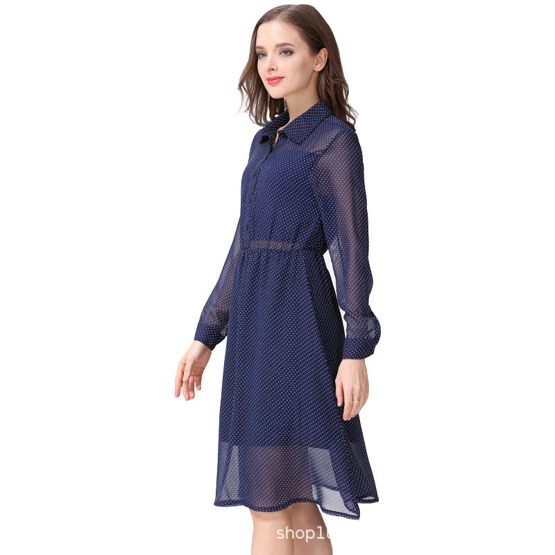 Side view of a woman wearing a navy polka dot maternity nursing dress with sheer long sleeves by Mama's Dream