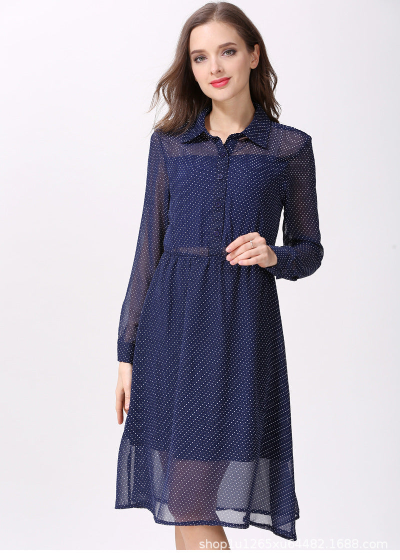 Woman wearing a navy polka dot maternity nursing shirt dress with long sleeves and a button front by Mama's Dream