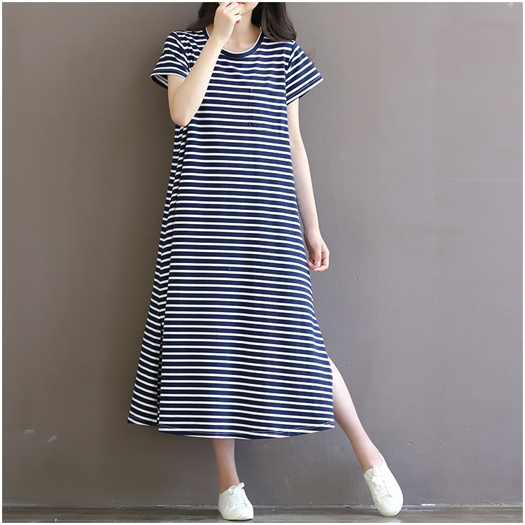 Woman wearing a loose-fit navy and white striped maternity maxi dress with short sleeves by Mama's Dream