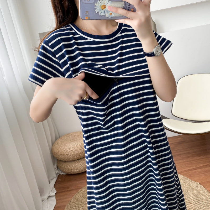 Woman showing a hidden front pocket in a navy and white striped maternity dress by Mama's Dream
