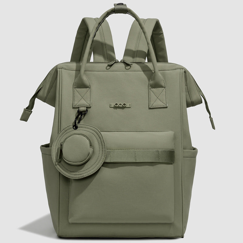 Olive green convertible diaper bag backpack with top handles, side pockets and front storage compartment by Mama's Dream