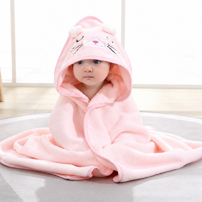 Baby wrapped in a soft pink hooded bath towel with an embroidered cat design by Mama's Dream