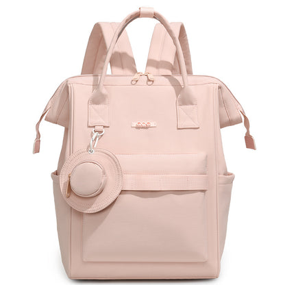 Blush pink convertible diaper bag backpack with top handles, side pockets and front storage compartment by Mama's Dream