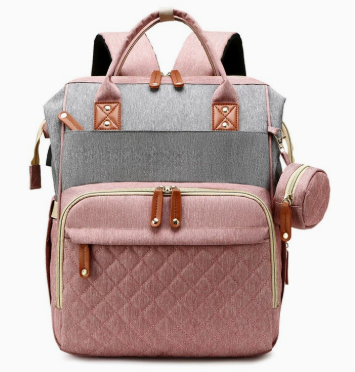 Pink and gray diaper bag backpack with quilted front pocket, top handles and side accessory pouch by Mama's Dream