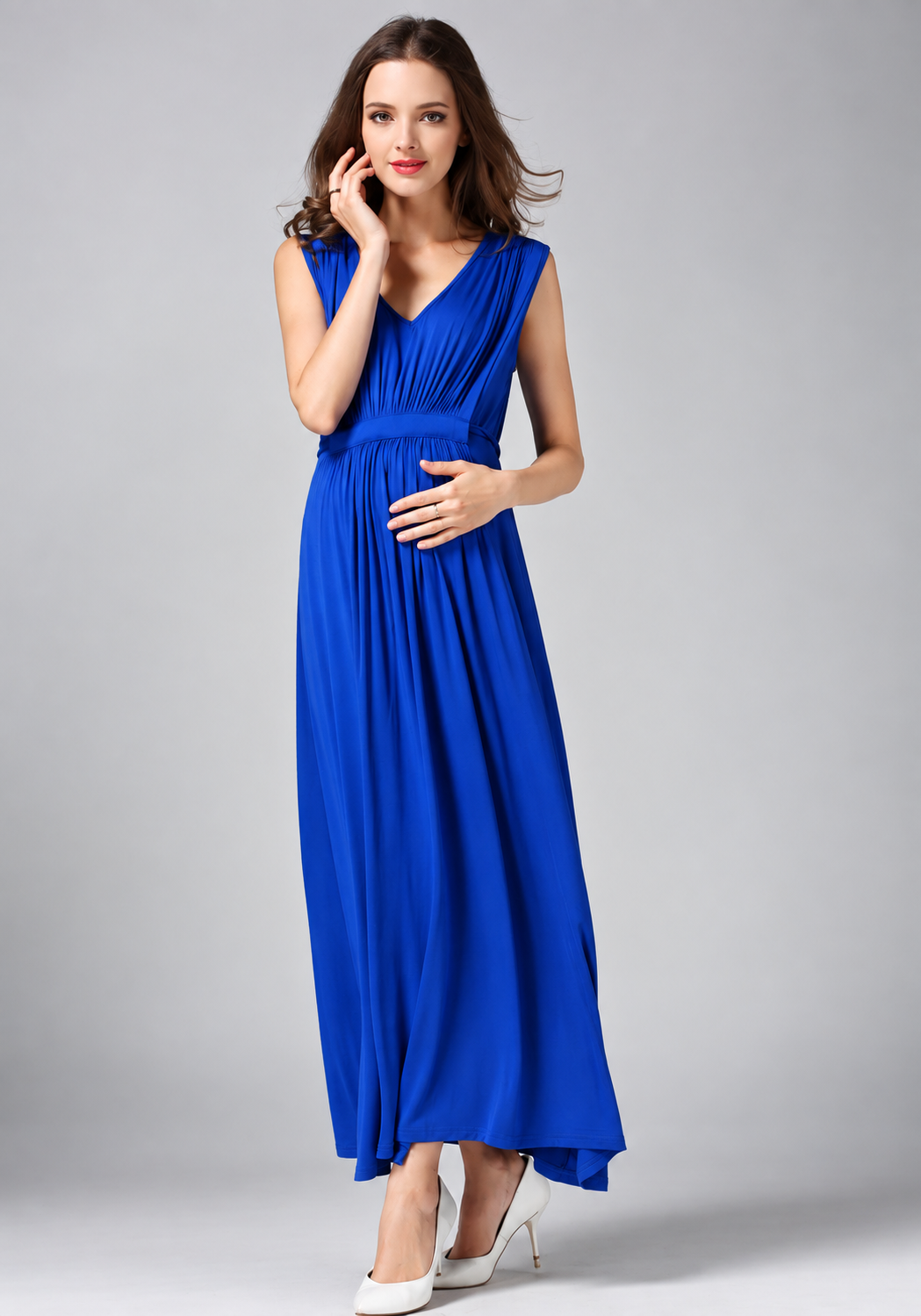 Pregnant woman wearing a royal blue sleeveless V-neck maternity maxi dress with an empire waist by Mama's Dream
