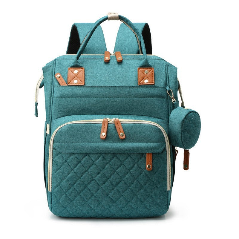 Teal quilted diaper bag backpack with top handles, padded shoulder straps and side accessory pouch by Mama's Dream